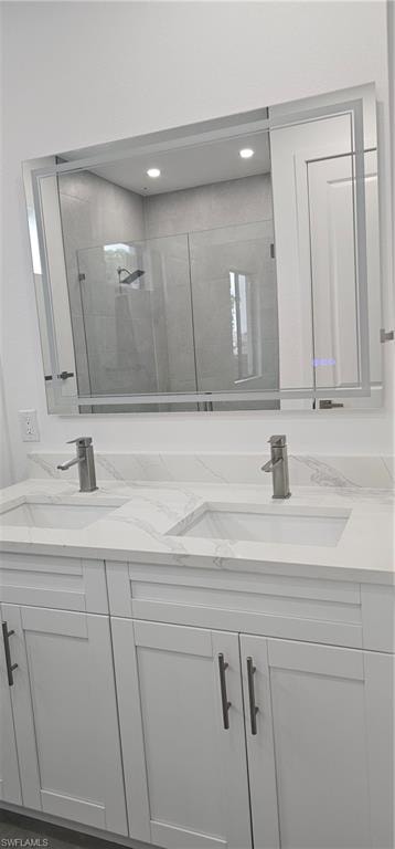 Full bathroom with a shower stall and double vanity