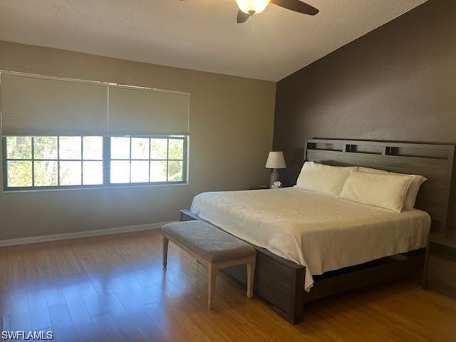 Bedroom featuring wood finished floors and ceiling fan