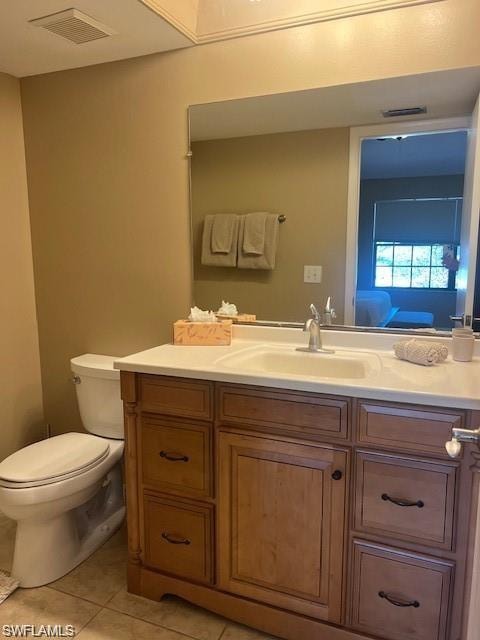 Ensuite bathroom with vanity and light tile patterned floors