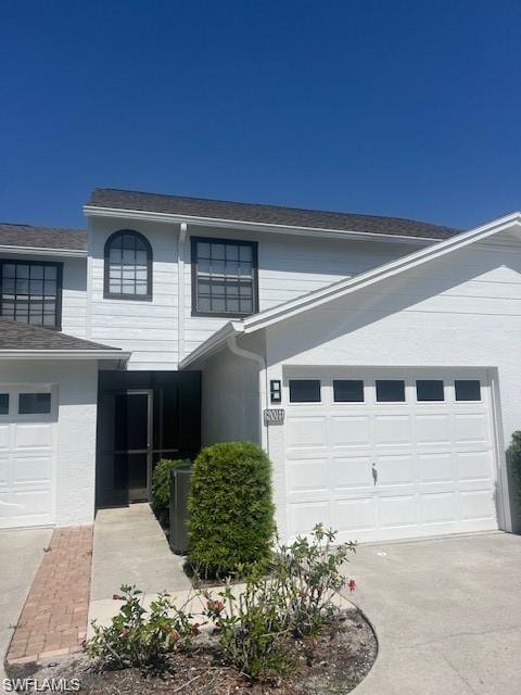 Traditional-style home with an attached garage and driveway