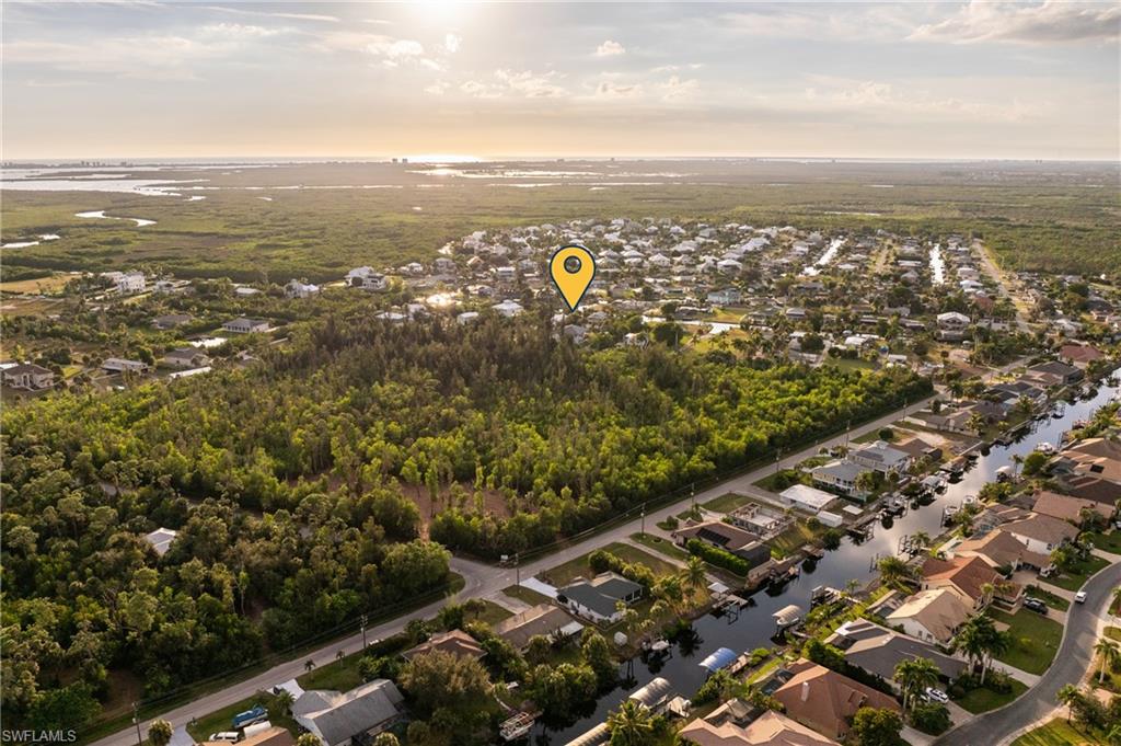 View of property location featuring a nearby body of water and nearby suburban area