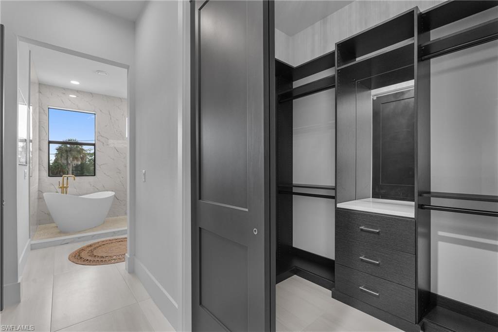 Spacious closet with light tile patterned flooring
