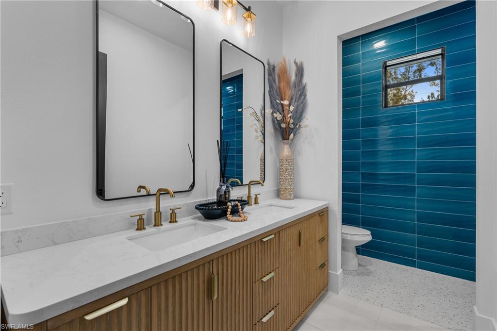 Bathroom with double vanity and toilet