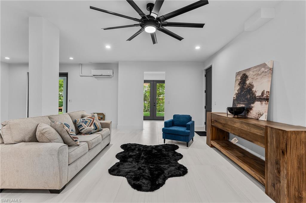 Living area featuring plenty of natural light, recessed lighting, french doors, and ceiling fan