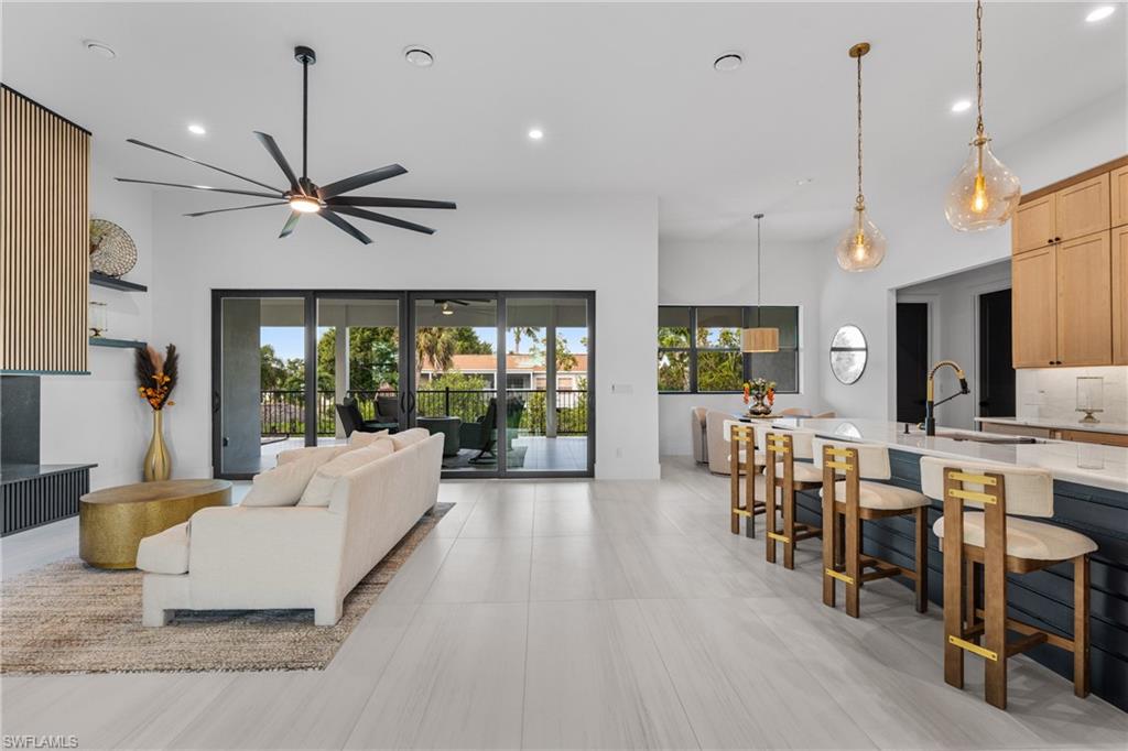 Living room with plenty of natural light, recessed lighting, and a ceiling fan