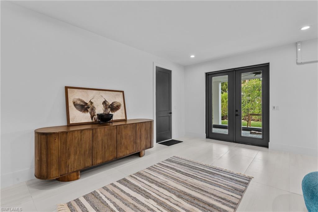 Entryway featuring french doors, recessed lighting, and a wall mounted air conditioner