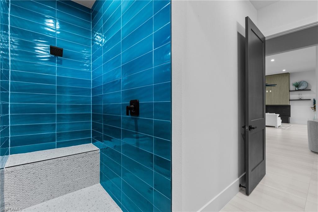 Full bath featuring tiled shower