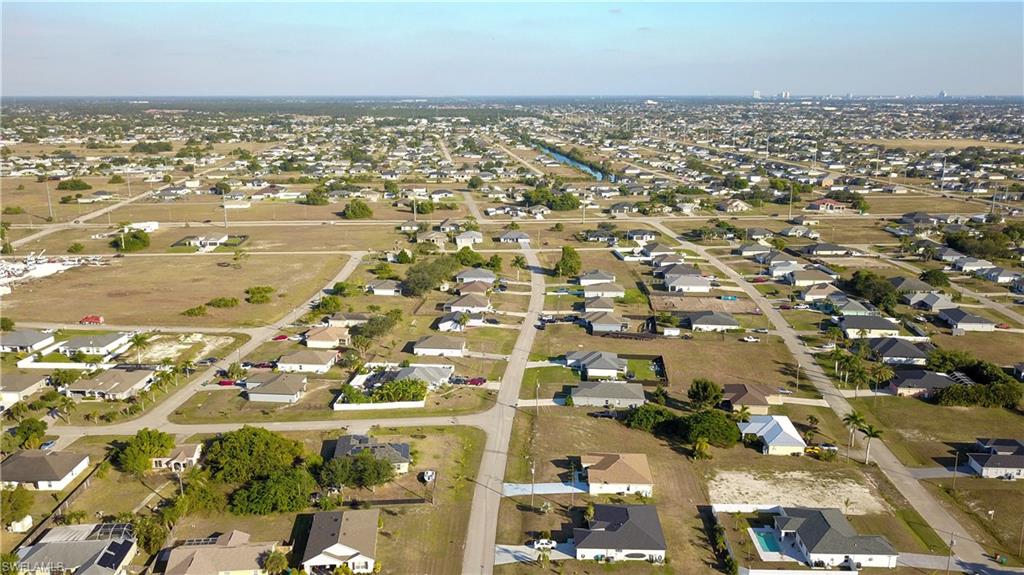 Aerial view of property's location with nearby suburban area