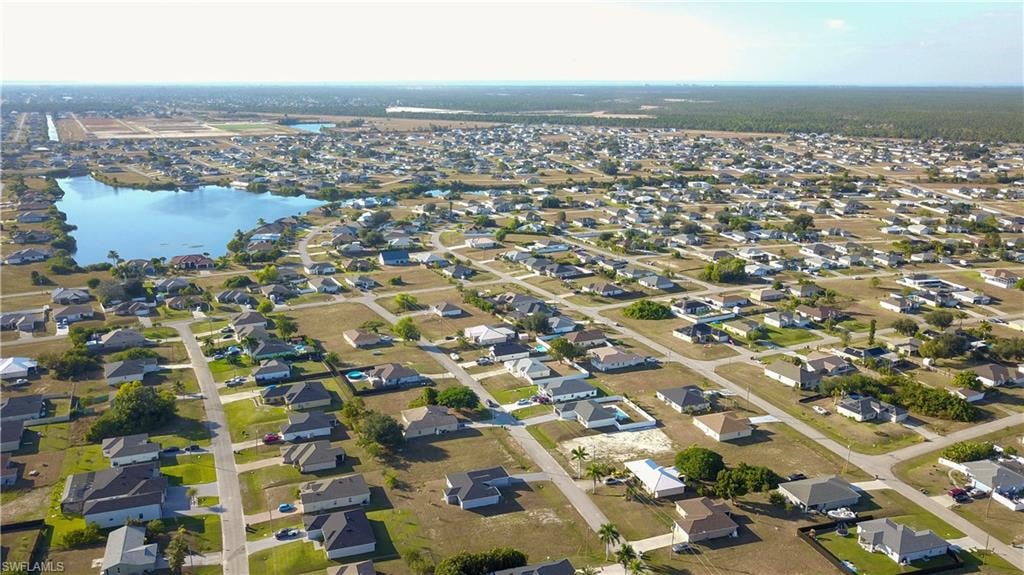 Aerial overview of property's location featuring a nearby body of water and nearby suburban area