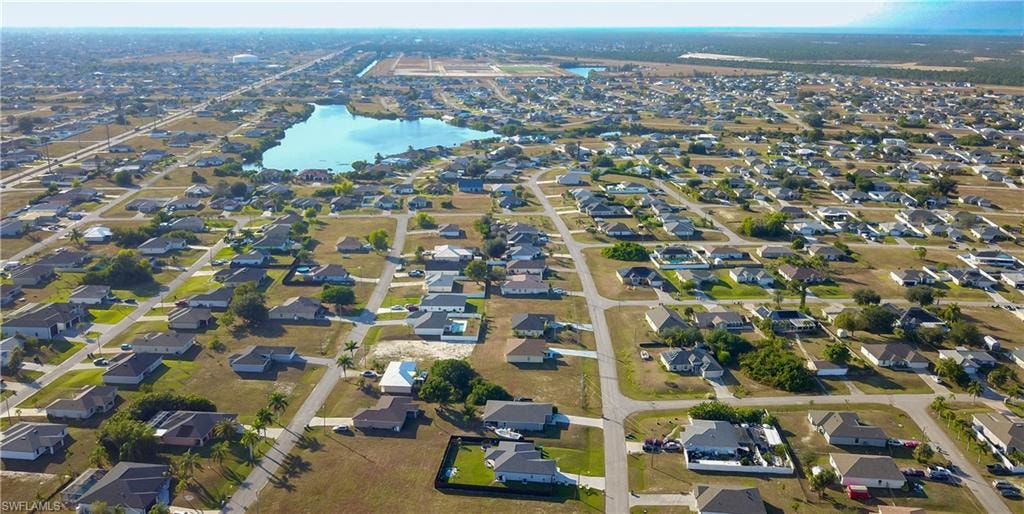 View of property location featuring a large body of water and nearby suburban area
