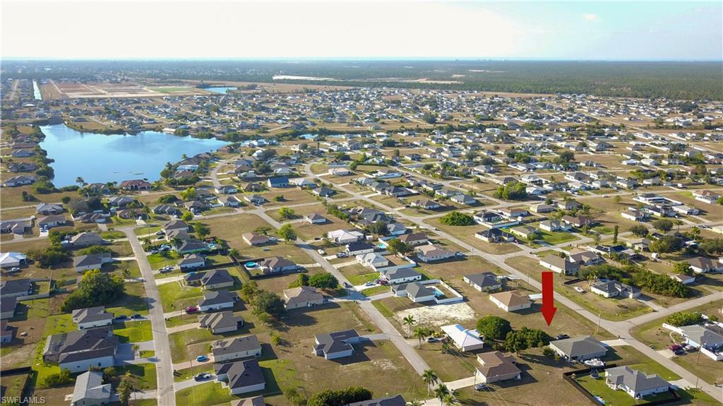 Aerial overview of property's location featuring nearby suburban area and a nearby body of water