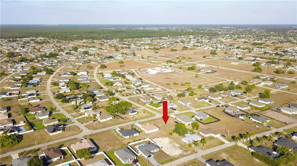 Aerial overview of property's location featuring nearby suburban area