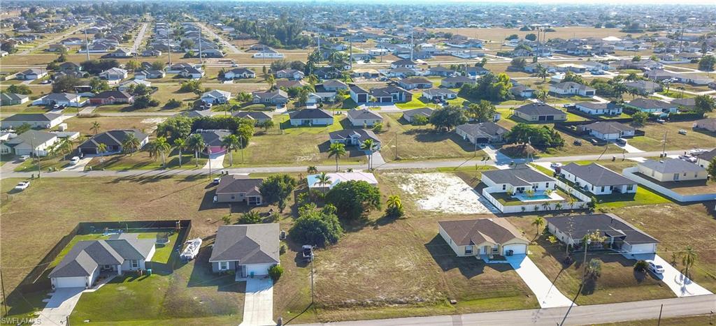Aerial view of property's location featuring nearby suburban area