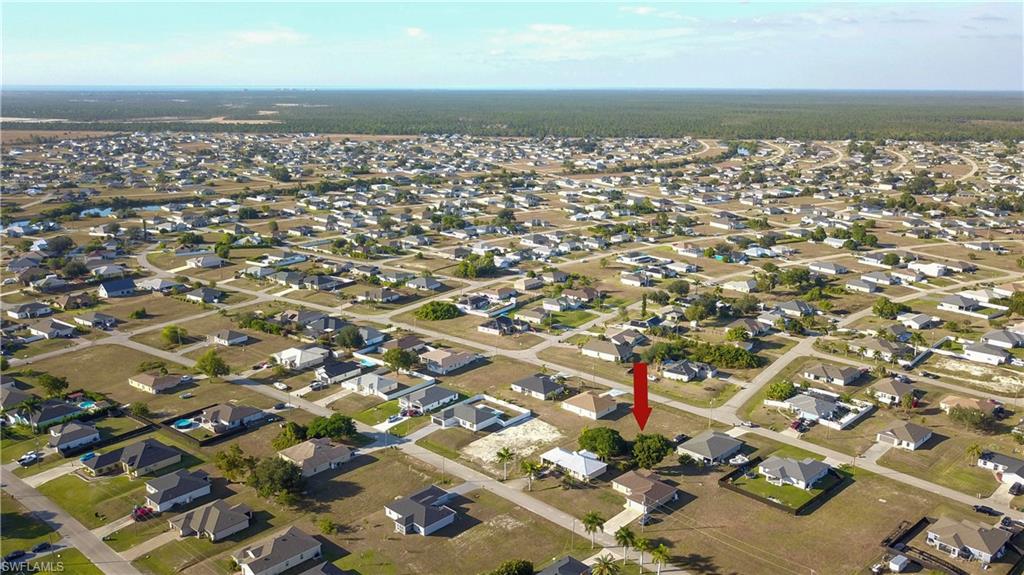 Aerial view of property's location with nearby suburban area
