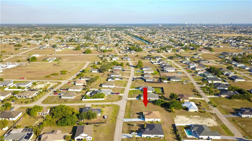Aerial view of property's location with nearby suburban area
