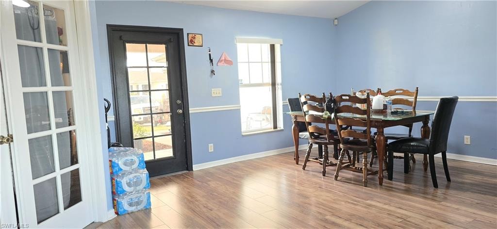 Dining room featuring wood finished floors and baseboards