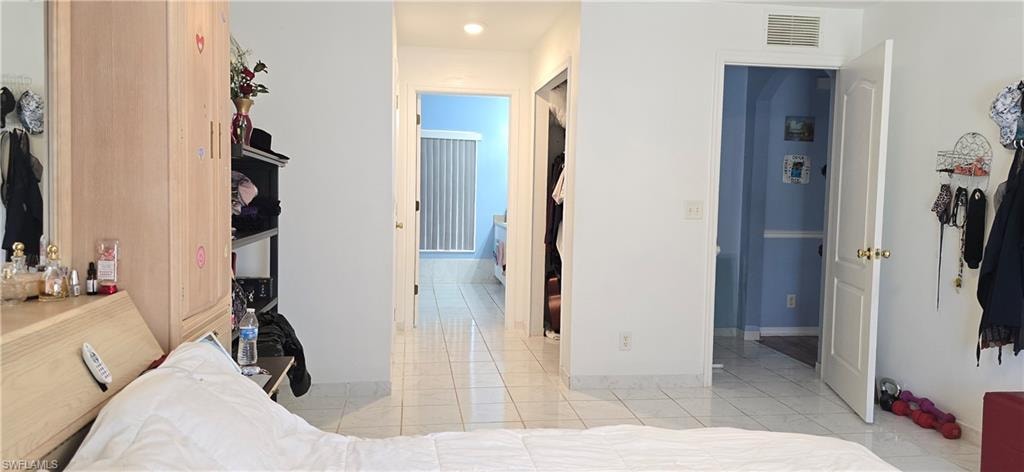 Bedroom featuring a closet and light tile patterned floors