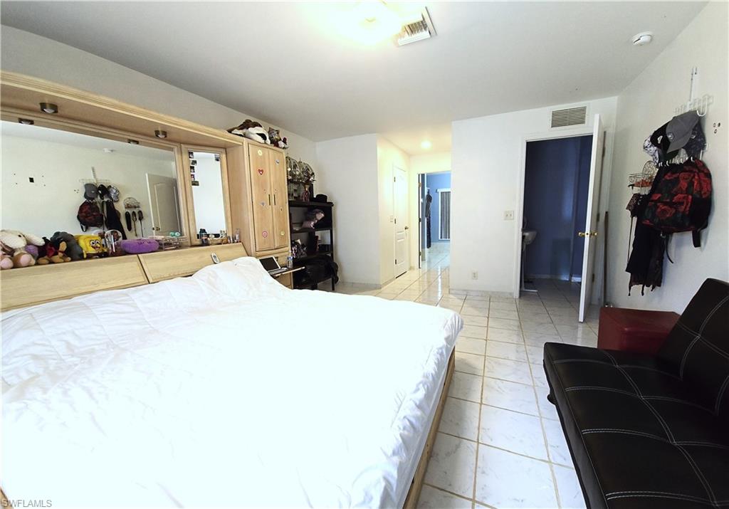 Bedroom featuring light tile patterned flooring