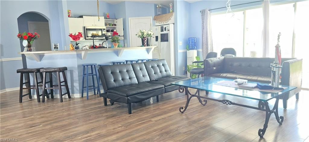 Living area featuring wood finished floors and vaulted ceiling