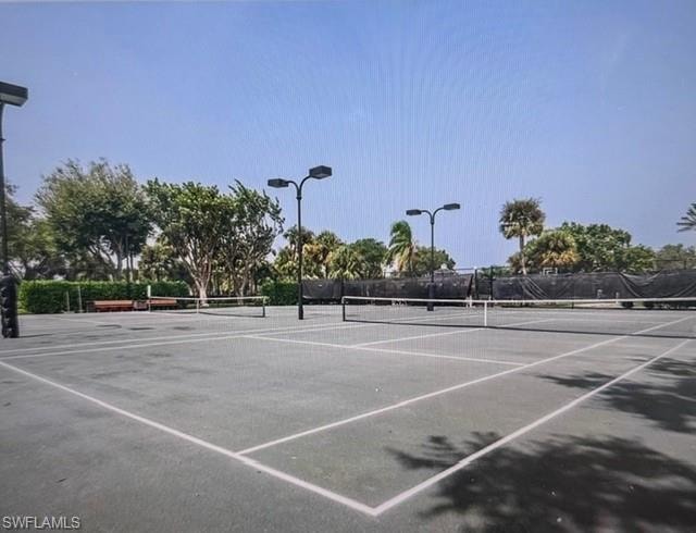 View of tennis court with community basketball court