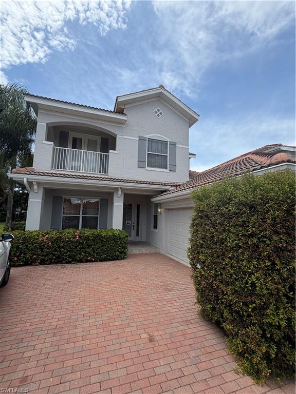 Two-story stucco exterior with a tile roof and decorative shutters