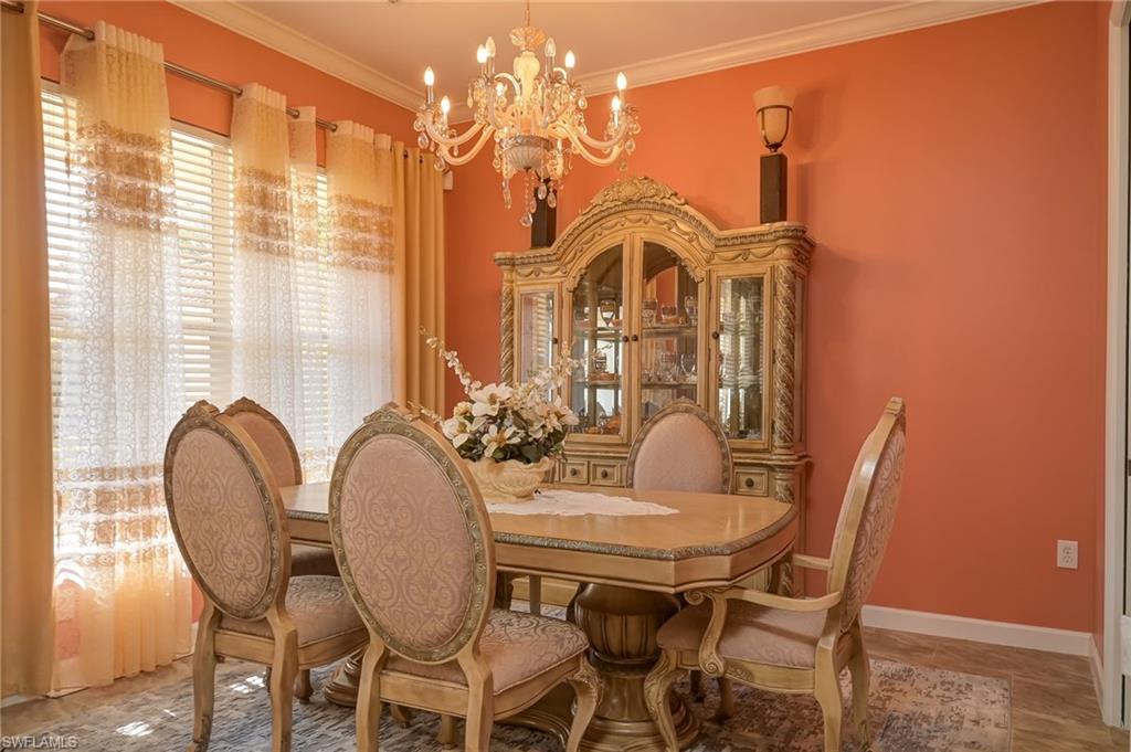 Dining area featuring ornamental molding and a chandelier