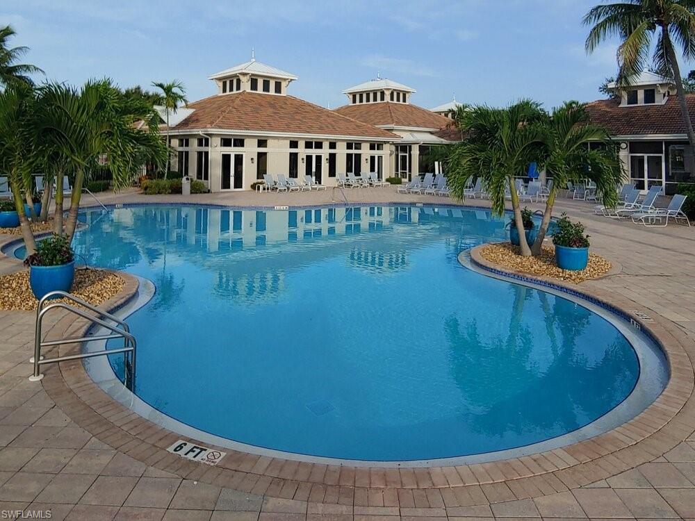 Community pool with a patio