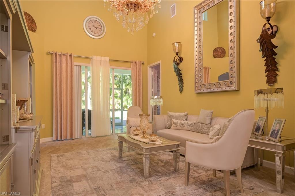 Living area featuring a high ceiling and a chandelier