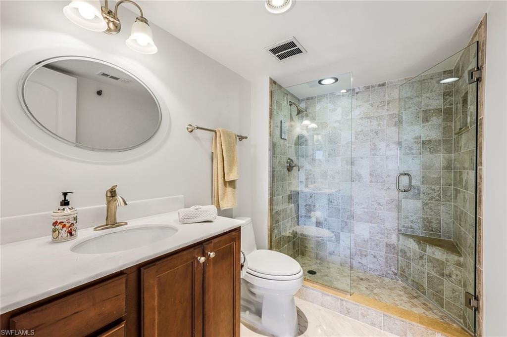 Bathroom with vanity and a shower stall