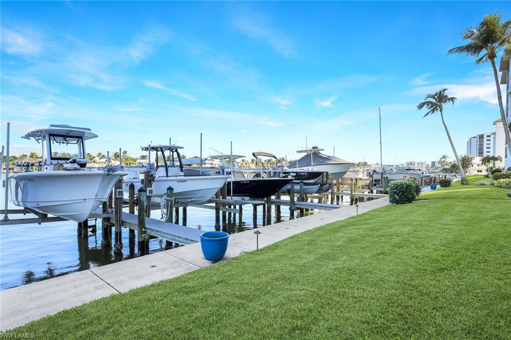 Dock featuring a yard, a water view, and boat lift