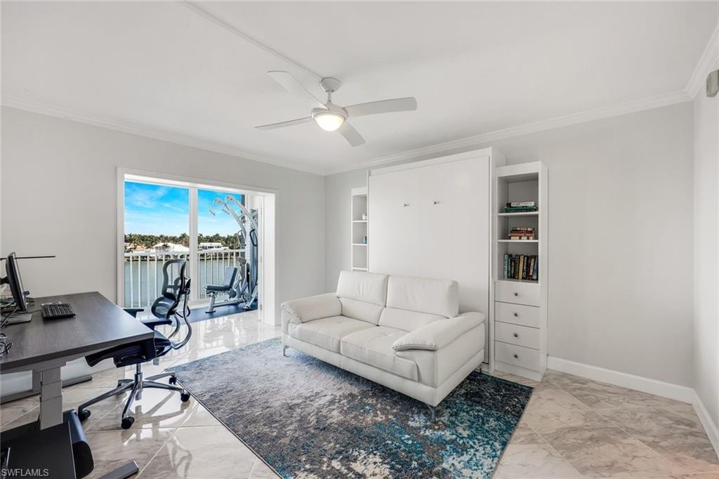 Office with light marble finish floors, ornamental molding, a water view, and a ceiling fan