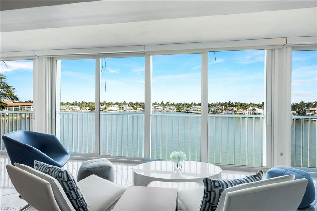 Sunroom featuring a water view