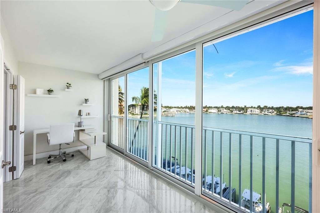 Sunroom featuring a water view