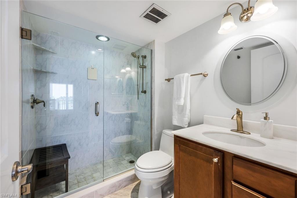 Bathroom with vanity and a shower stall