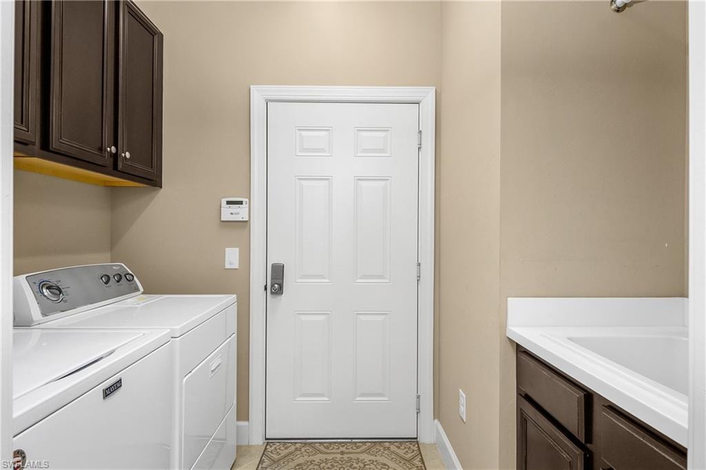Laundry with utility sink and additional storage.