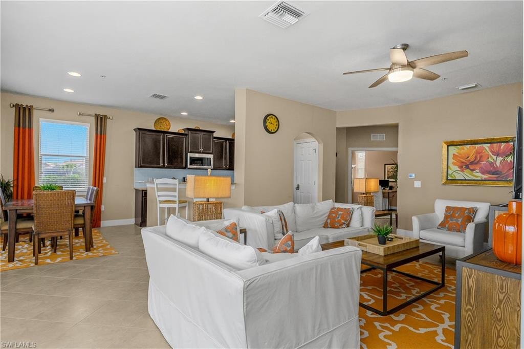 Open Great room, kitchen, dining space offers lots of natural light and tile flooring throughout the entire home (no carpet).