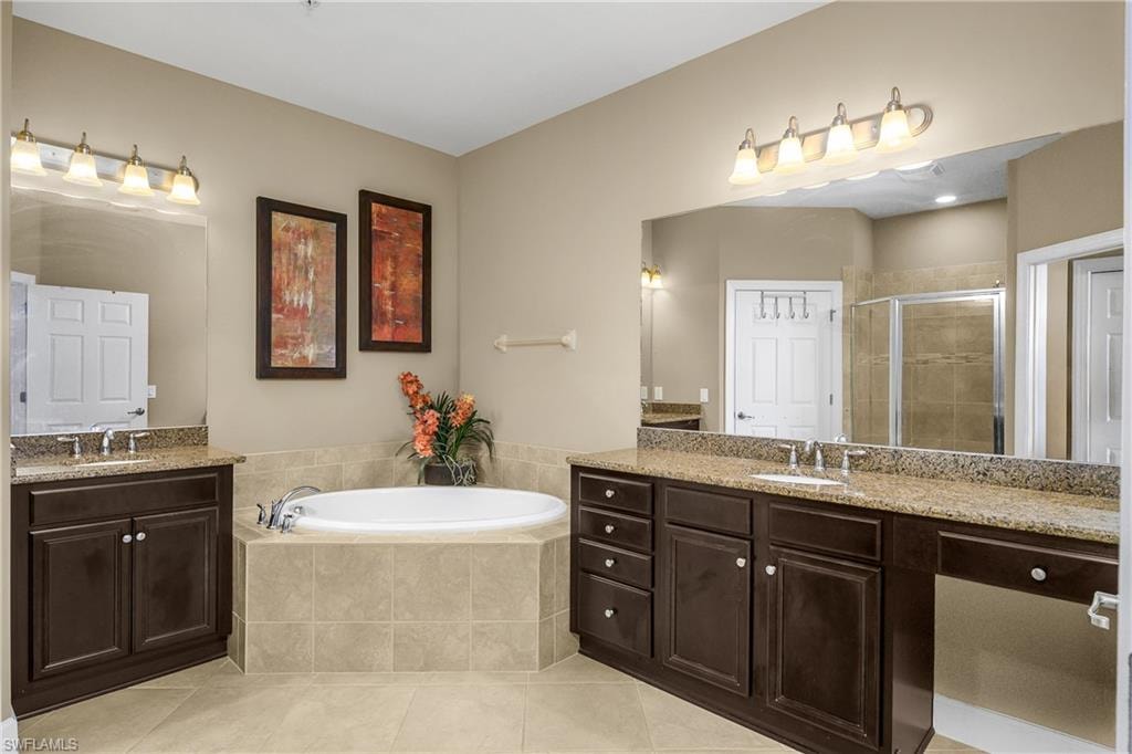 Spa-like primary bath features dual sinks and vanities, soaking tub, and walk-in shower.