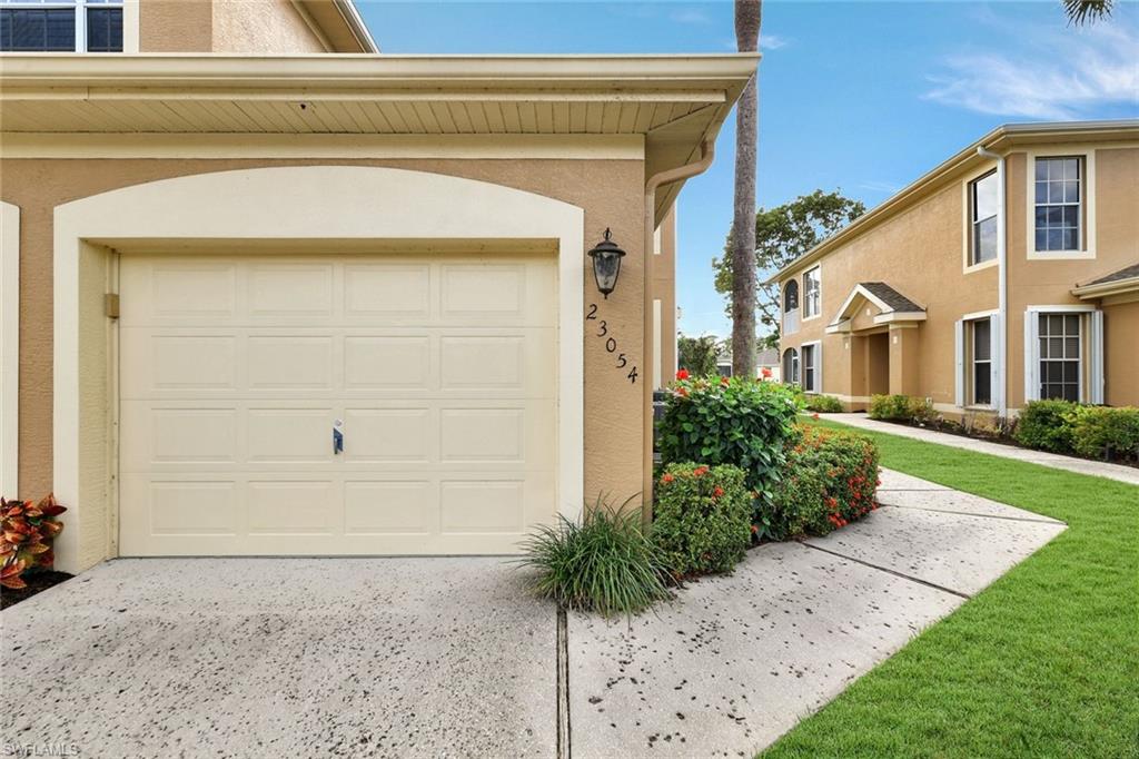 Garage featuring concrete driveway