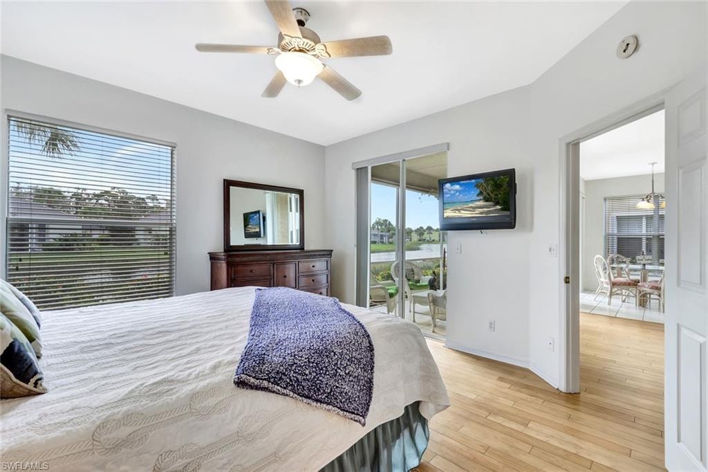 Bedroom featuring access to exterior, multiple windows, light wood finished floors, and a ceiling fan