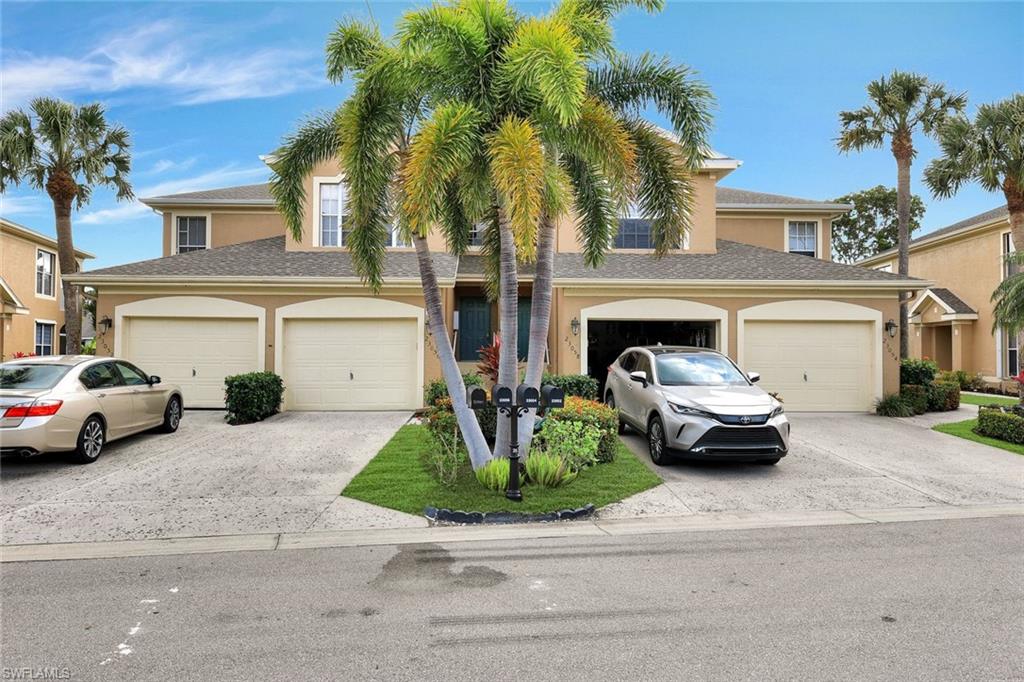 Townhome / multi-family property with an attached garage, concrete driveway, and stucco siding