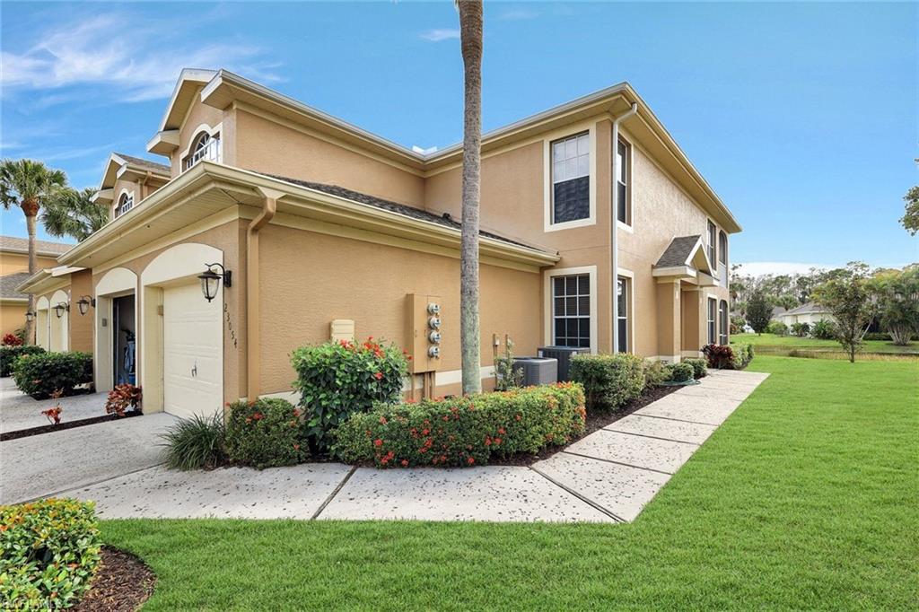View of home's exterior with a yard and stucco siding