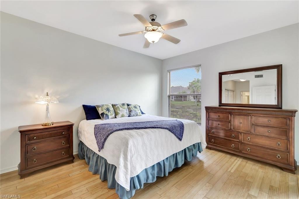 Bedroom featuring a ceiling fan, light wood-type flooring, and visible vents