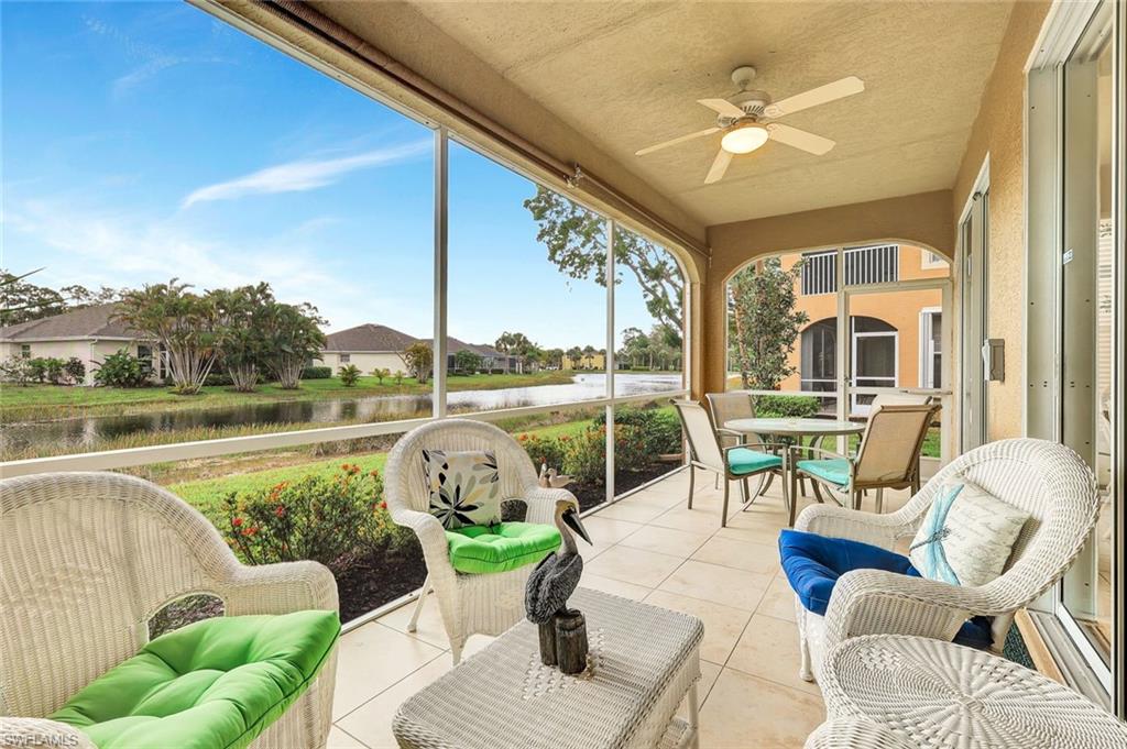 Tiled Lanai featuring a ceiling fan and a water view