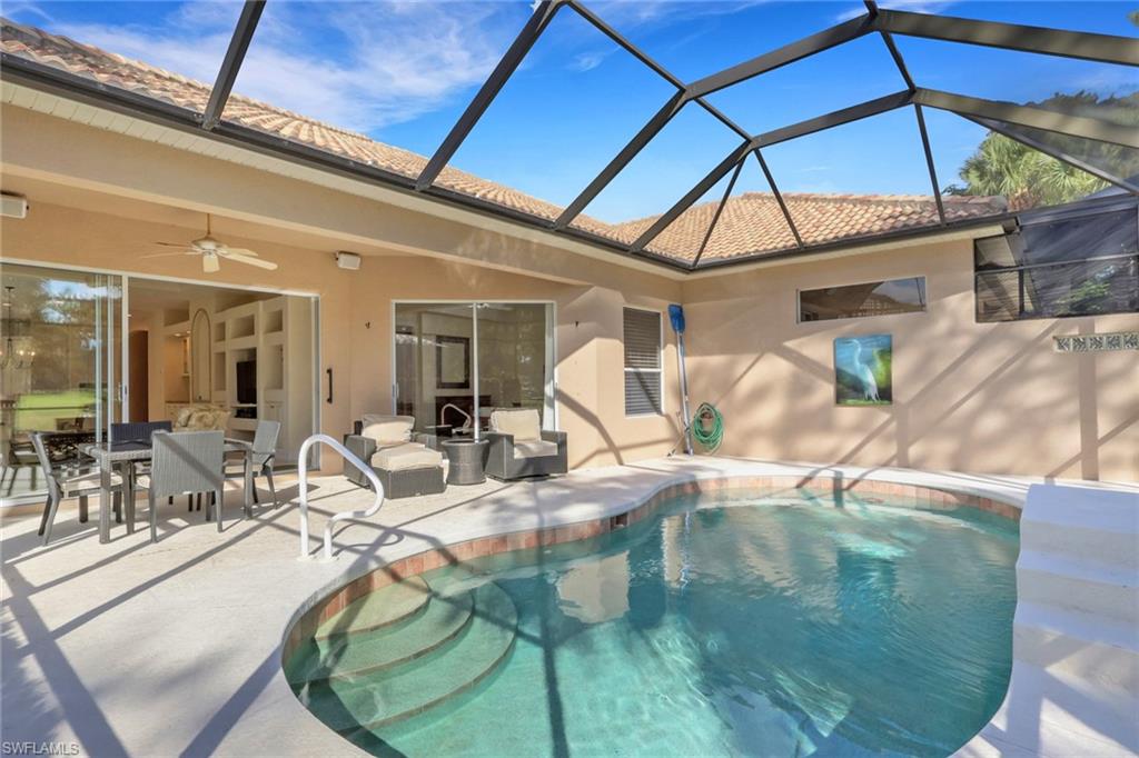 Outdoor pool featuring a sunroom, outdoor dining space, a lanai, a ceiling fan, and a patio area