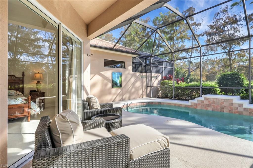 Swimming pool featuring a patio, a lanai, and a sunroom