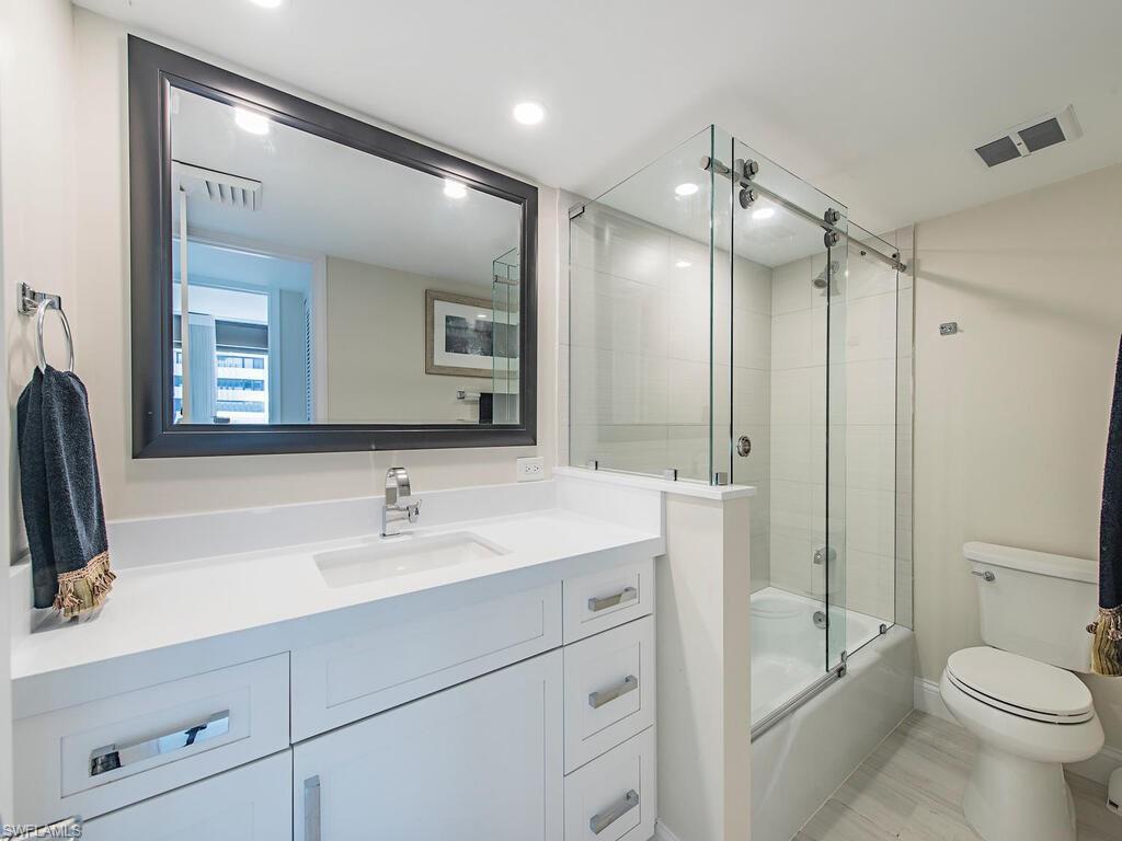 Full bathroom featuring vanity, combined bath / shower with glass door, and recessed lighting
