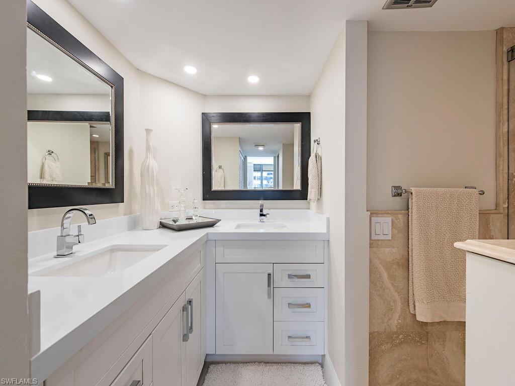 Full bathroom with double vanity and recessed lighting