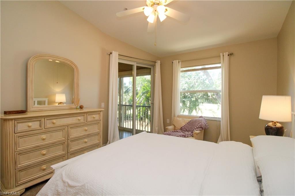 Bedroom with access to outside, ceiling fan, and vaulted ceiling