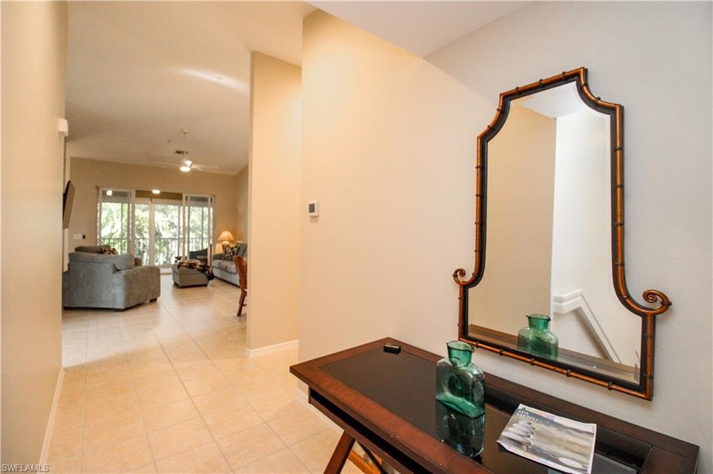 Hallway with light tile patterned floors