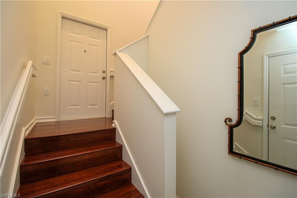Stairway featuring hardwood / wood-style flooring